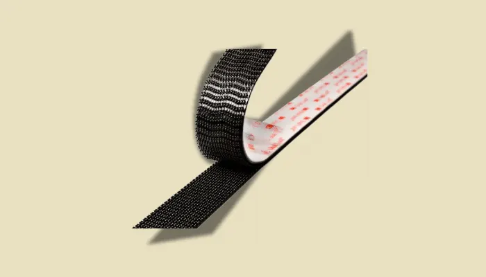 Close-up of Dual Lock tape strips used for securely mounting guitar pedals to a pedalboard, offering strong hold with easy repositioning.