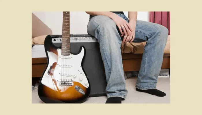 Photo of a guitar and amplifier, the basic gear you need before adding effects pedals.