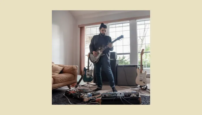 A guitarist playing with a high headroom amp and pedals.