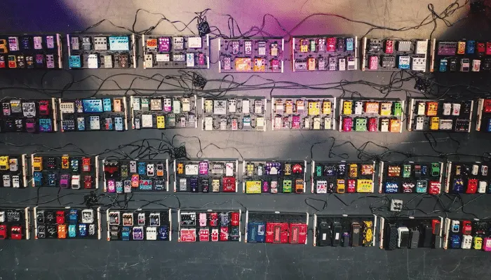 Photo of a very long guitar pedalboard, illustrating why a buffer helps maintain signal integrity.