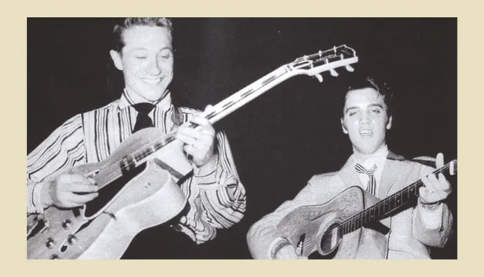 Vintage black and white photo of Scotty Moore with electric guitar and Elvis Presley.