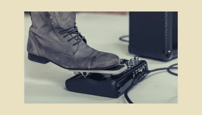 Photo of a guitarist's foot on a wah pedal, illustrating foot-control technique.