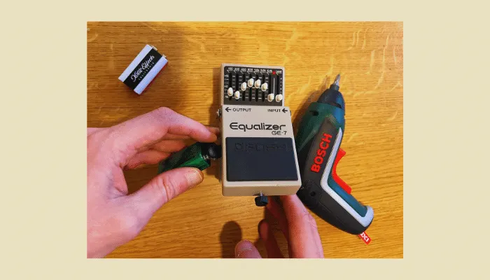 Photo of a 9V battery being changed in a guitar pedal, illustrating how often to replace it.