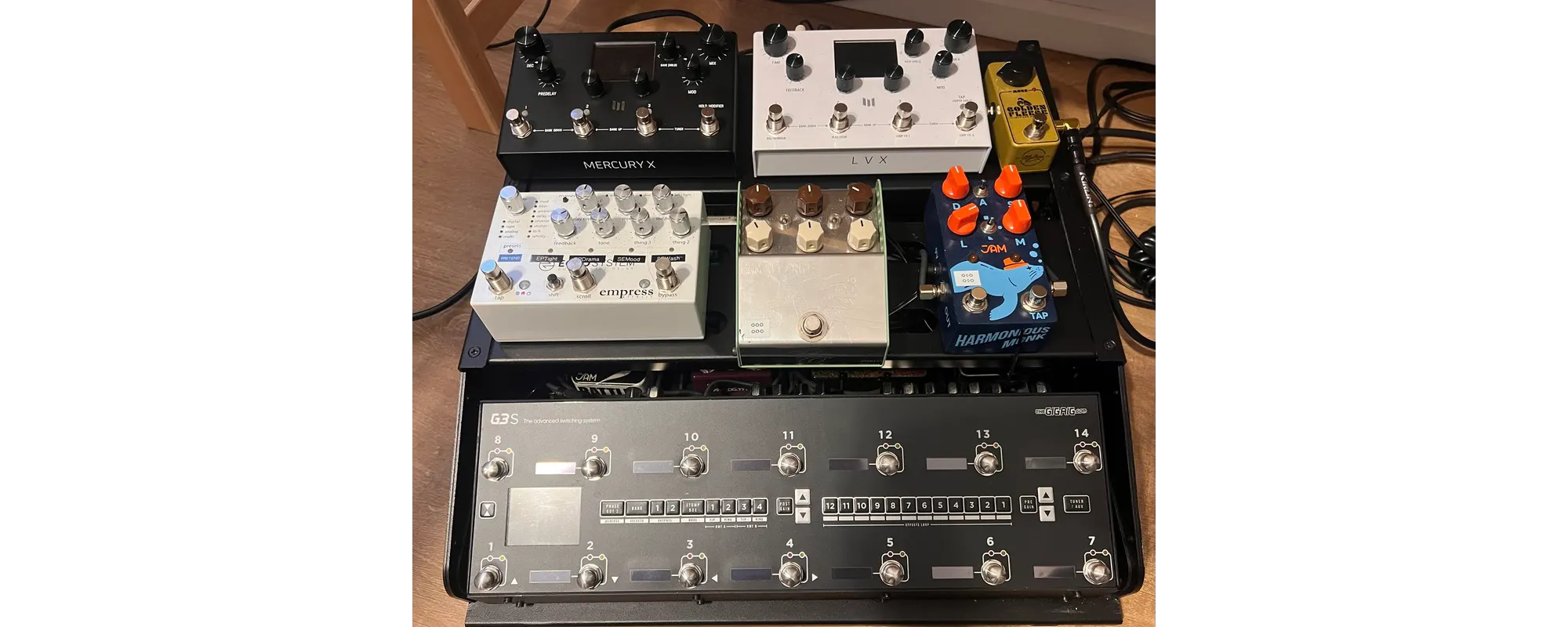 Gareth's own guitar pedalboard with the isolated power supply mounted underneath the board and patch cables routed with a small service loop of slack at each connection.