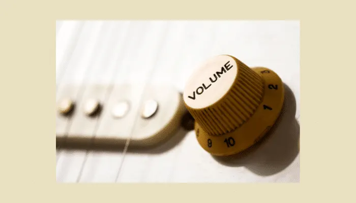 Close-up of a guitar’s volume knob, used to control signal strength and clean up fuzz tones.
