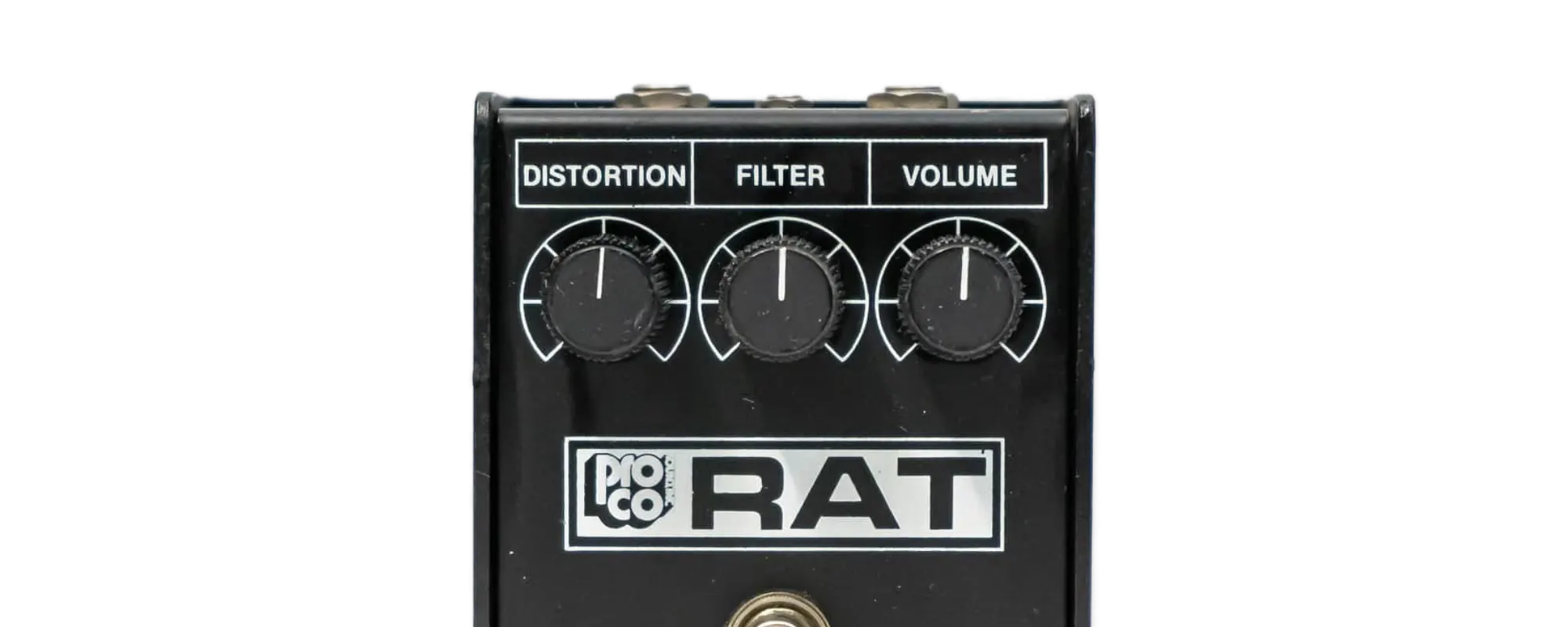Top-down macro of a ProCo Rat's three knobs — Distortion, Filter and Volume — with the Filter marked clockwise for darker and counter-clockwise for brighter