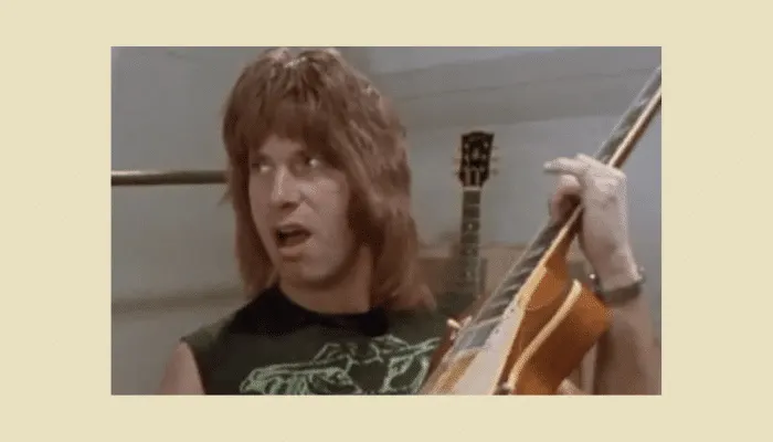 Photo referencing Nigel Tufnel from Spinal Tap, illustrating how a compressor adds sustain to your playing.