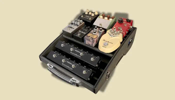 Photo of a tiered pedalboard, a raised board that helps organise multiple guitar pedals.