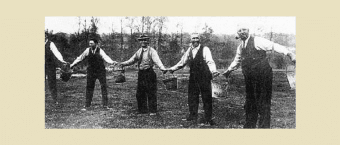 Guitar Delay Pedals: How They Work, Types & Setup Guide 4 Historical black and white photo of firefighters passing water buckets in chain formation